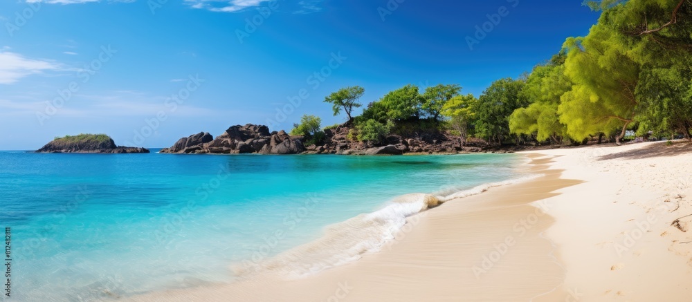 An idyllic sandy beach paradise with a blue lagoon transparent water fresh green trees and no people The sunny weather and scattered clouds make Anse Lazio the perfect copy space image