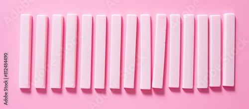 A flat lay of delicious chewing gum sticks arranged on a pink backdrop providing ample space for accompanying text © HN Works