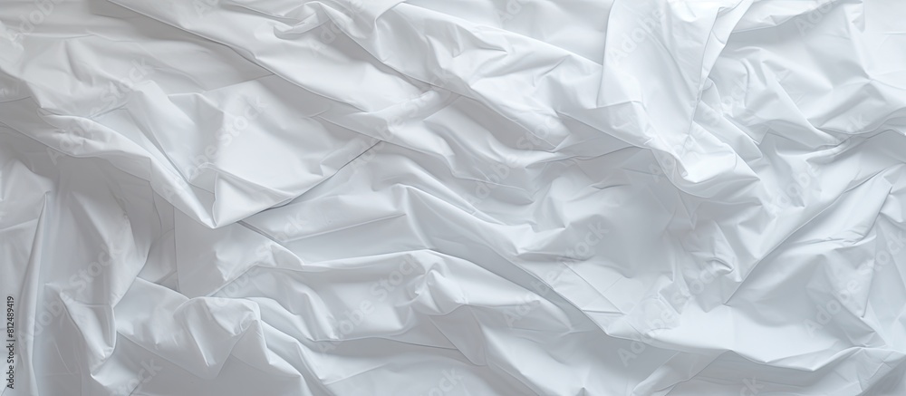 A white crumpled paper with a textura texture or background providing ample copy space image A white crumpled paper with a textura texture or background providing ample copy space image