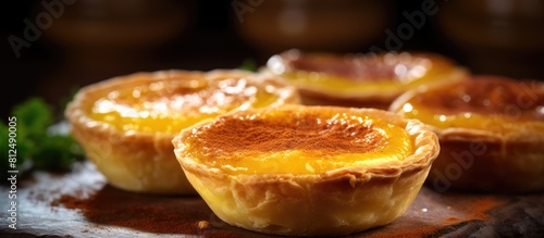 A delicious Portuguese egg tart enjoyed in the culinary haven of Macao with perfect flaky pastry and a creamy custard filling. Creative banner. Copyspace image photo