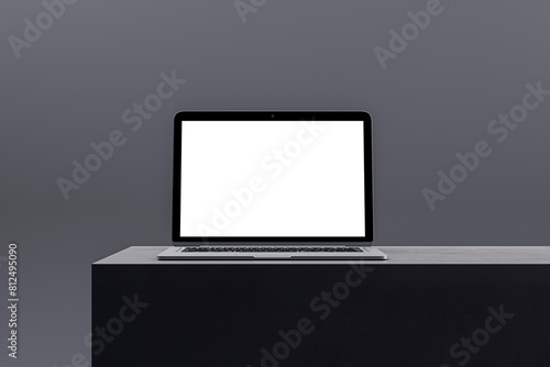 Stylish laptop with a blank screen on a minimalist podium, tailored for digital marketing and business presentations. 3D Render © Who is Danny
