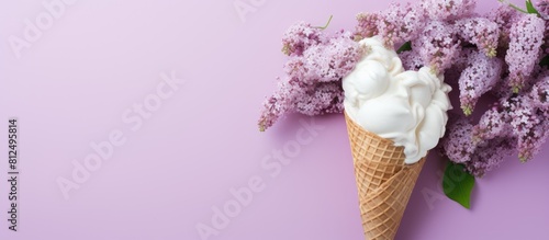 The image displays a bird s eye view of an ice cream cone surrounded by white lilacs with an empty card placed nearby This minimalistic composition evokes a spring atmosphere The arrangement is captu photo