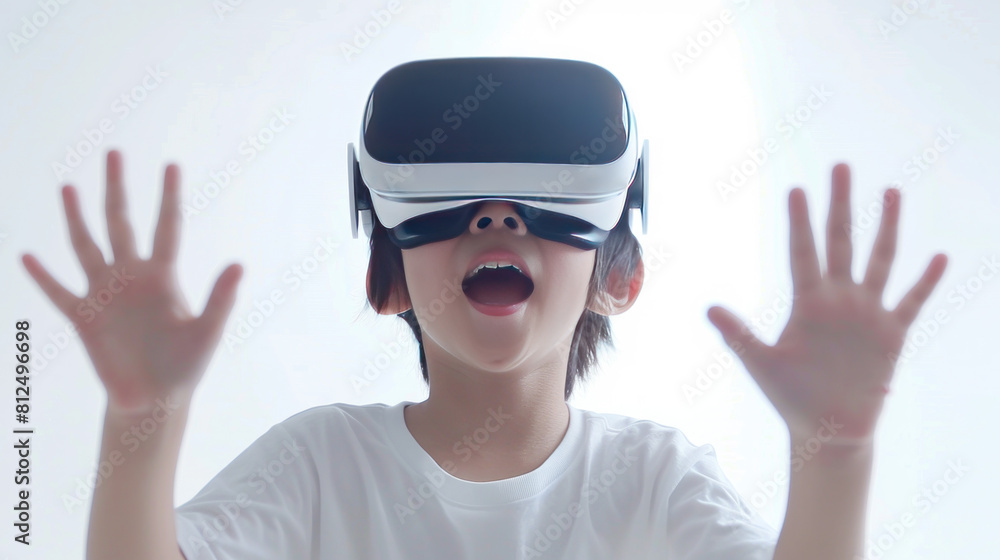 A young boy wearing a virtual reality headset is playing a game. He is making a funny face and is excited about the game A young boy wearing a virtual reality headset is playing a game. He is making a funny face and is excited about the game