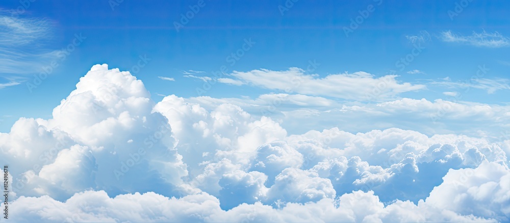 A background image showing a spacious expanse of blue sky and fluffy clouds perfect for adding text or other elements. Creative banner. Copyspace image A background image showing a spacious expanse of blue sky and fluffy clouds perfect for adding text or other elements. Creative banner. Copyspace image