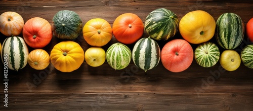 A mouthwatering assortment of freshly picked melons displayed on a rustic wooden table captured from above Plenty of room for adding text in the copy space image