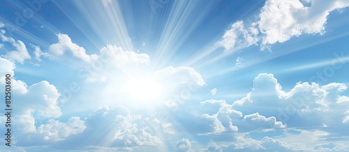 A picturesque setting with sunbeams lens flares and clouds against a blue sky perfect for a copy space image