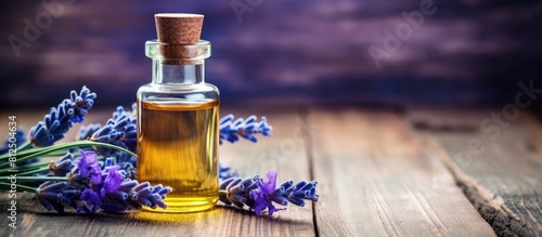 A relaxing lavender essential oil with its soothing aroma captured on a beautiful blue textured wood background creating a spa inspired concept The image provides a calming atmosphere with its lavend photo