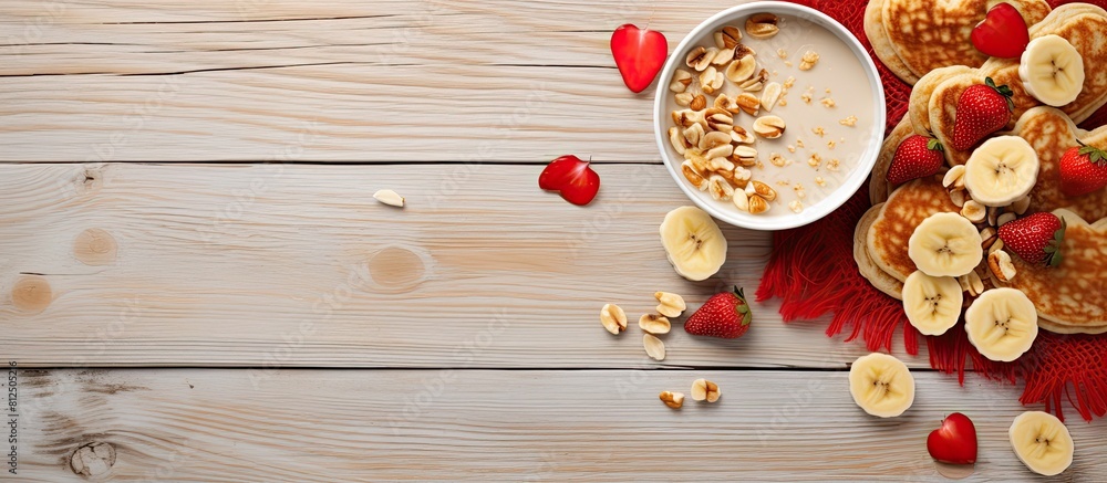 Valentine s Day celebration with heart shaped pancakes dried banana and nuts on a light wooden background A delightful copy space image Valentine s Day celebration with heart shaped pancakes dried banana and nuts on a light wooden background A delightful copy space image