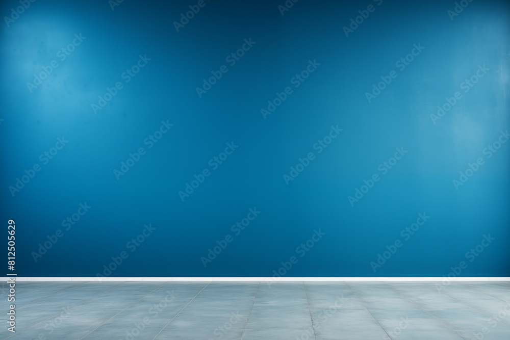 Empty room with blue wall and tiled floor under natural light for various uses.