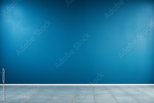 Empty room with blue wall and tiled floor under natural light for various uses.