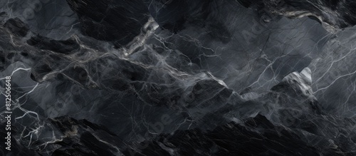 The abstract black background showcases a grey marble texture providing a visually captivating copy space image