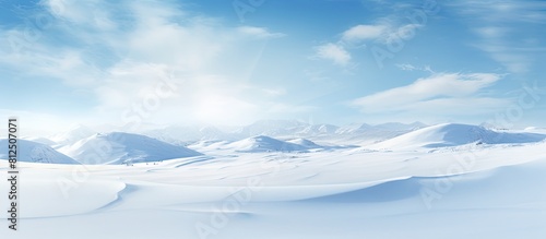 Winter landscape with snowy ground and wind sculpted patterns on the snow surface creating a wide panoramic background The natural snow texture adds to the beauty of the copy space image