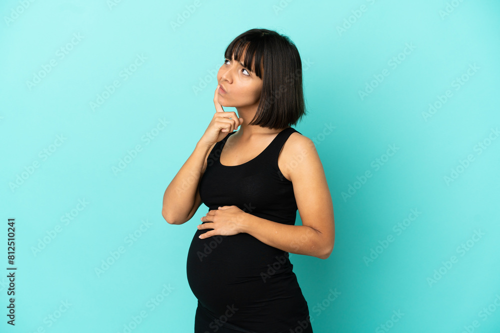 Woman over isolated background pregnant and thinking Woman over isolated background pregnant and thinking