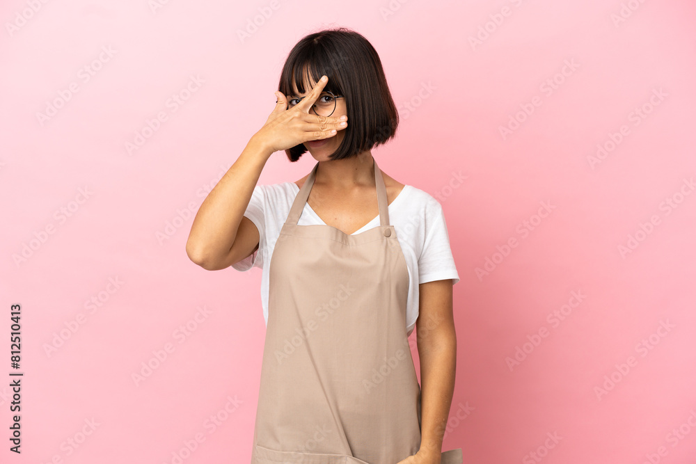 Restaurant waiter over isolated pink background covering eyes by hands and smiling Restaurant waiter over isolated pink background covering eyes by hands and smiling