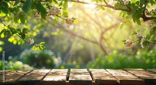 Serene nature scene with fresh spring blossoms above a rustic wooden table, enhanced by the warm golden sunlight photo