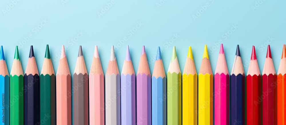 A vibrant arrangement of colored pencils against a pastel backdrop creating a visually captivating copy space image A vibrant arrangement of colored pencils against a pastel backdrop creating a visually captivating copy space image