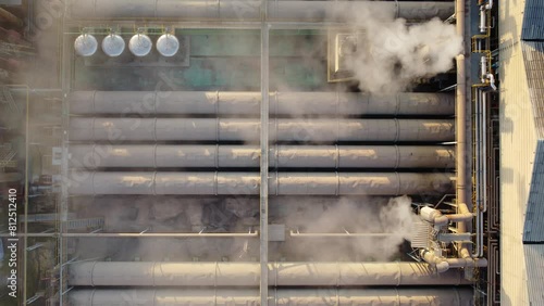 Footage 4K over the Chemical plant cooling tower smoke equipment.  The drone fly over the industrial roofs and cooling tower equipment with smoke exhaust in chemical plants.