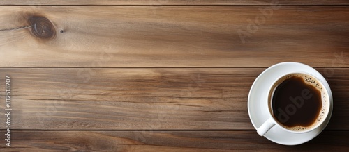 A coffee cup viewed from above on a wooden table with a background for copy space image