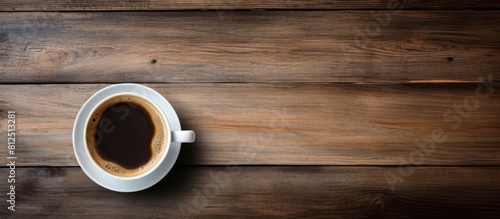 A coffee cup viewed from above on a wooden table with a background for copy space image