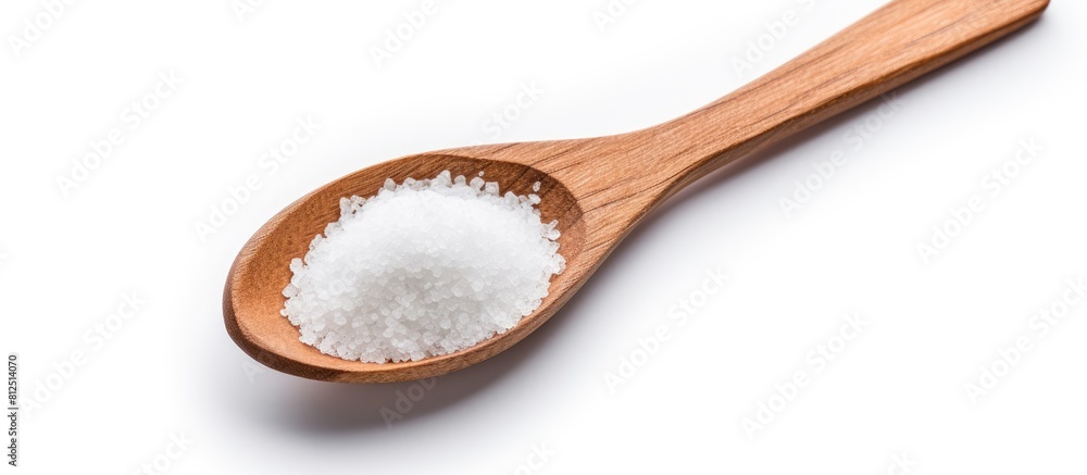 A wooden spoon filled with sea salt isolated on a white background with copy space for an image A wooden spoon filled with sea salt isolated on a white background with copy space for an image