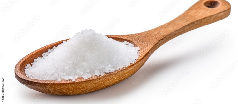 A wooden spoon filled with sea salt isolated on a white background with copy space for an image A wooden spoon filled with sea salt isolated on a white background with copy space for an image
