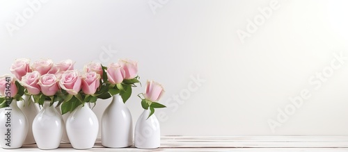 A white wooden table with a shade is adorned with beauty product samples and roses creating a visually appealing copy space image