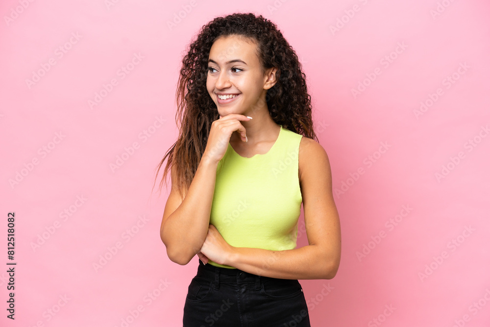 Young hispanic woman isolated on pink background looking to the side and smiling Young hispanic woman isolated on pink background looking to the side and smiling