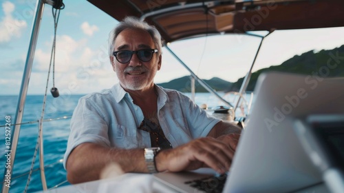 photography of a chilled out 65 year old CEO man working on laptop computer at a boat © ZoomTeam