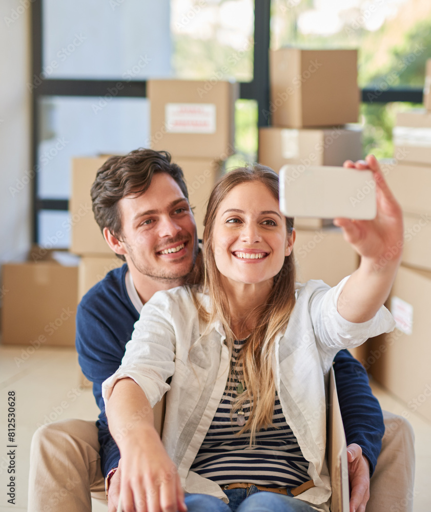 Happy couple, relax and moving in with selfie for photography, new home or picture at apartment. Young man and woman with smile or playing in box for memory in house, investment or property together Happy couple, relax and moving in with selfie for photography, new home or picture at apartment. Young man and woman with smile or playing in box for memory in house, investment or property together