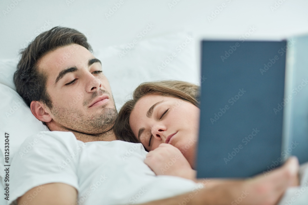 Relax, love and couple in bed with book, comfort and peace, care and bonding in their home with safety. Calm, reading and male person with novel in bedroom with sleeping wife on weekend in a house Relax, love and couple in bed with book, comfort and peace, care and bonding in their home with safety. Calm, reading and male person with novel in bedroom with sleeping wife on weekend in a house