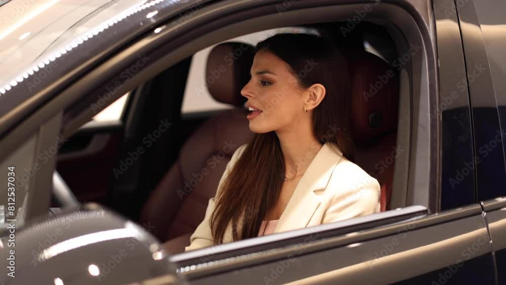 Young woman trying the car she wants to buy Young woman trying the car she wants to buy