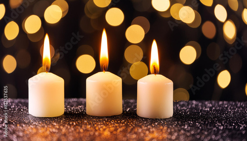 closeup of burning candles on abstract black background  contemplate celebration mood with blurry