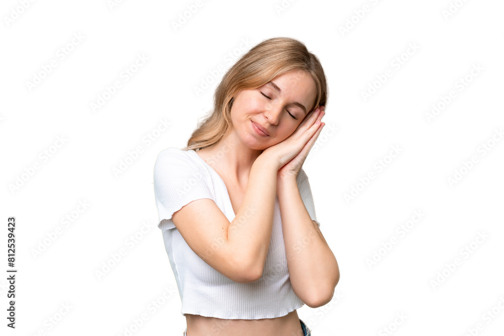 Young English woman over isolated background making sleep gesture in dorable expression