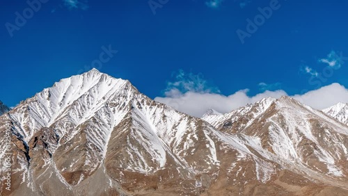 Time lapse of clouds and Kangju Kangri, at 22,064 feet, in the Karakoram Range of the Himalayas in India near the Tibet border photo