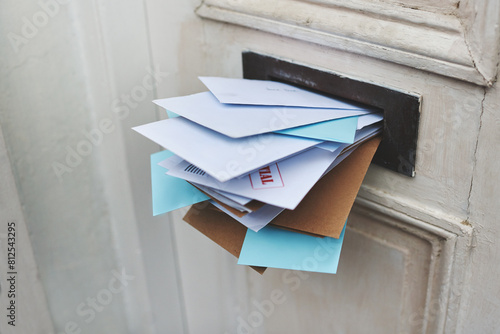 Door, letter and mail or envelope in box of home for communication or notice, stacked and overflowing with documents. Mailbox, post and address for mortgage or debt, message and paper from bank.