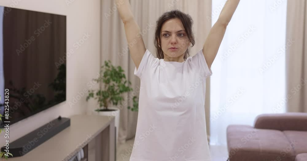 sporty woman warming up her muscles before training at home sporty woman warming up her muscles before training at home