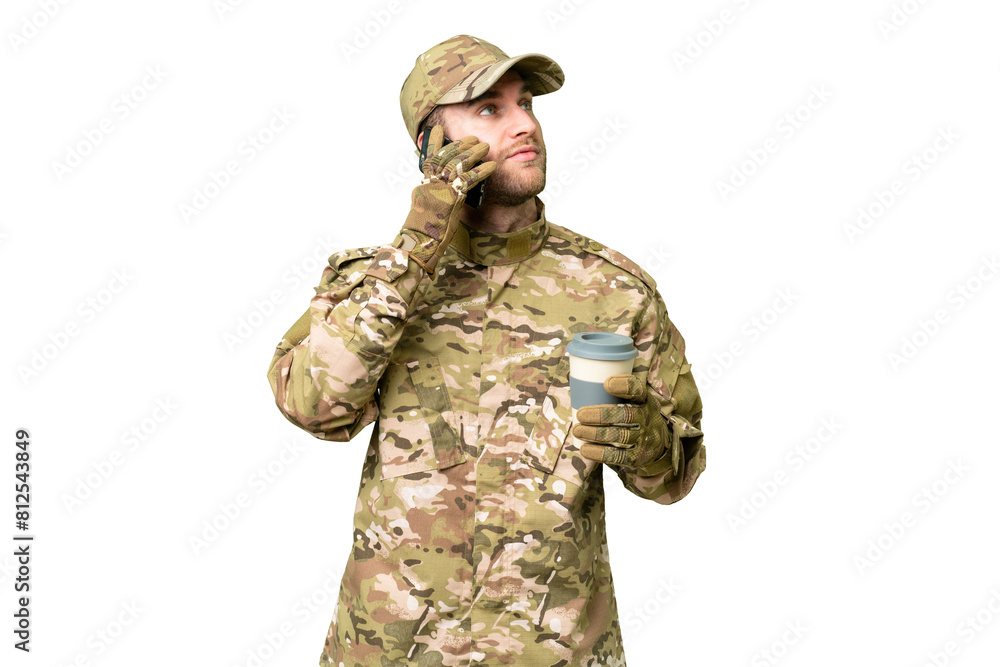 Military man over isolated chroma key background holding coffee to take away and a mobile