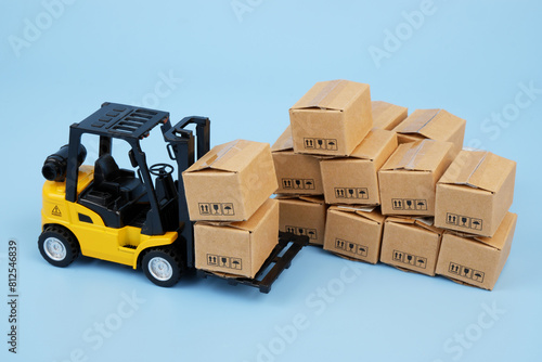 Many carton boxes and yellow forklift track. Cargo concept. 