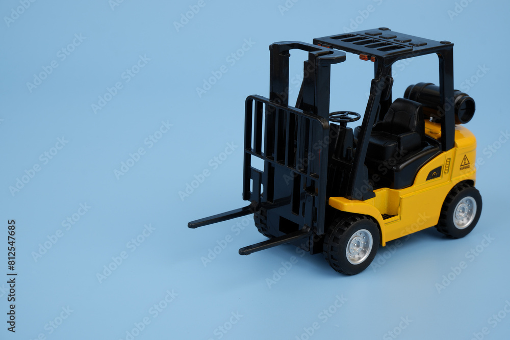 Forklift truck model on blue background. Copy space for text. Forklift truck model on blue background. Copy space for text.