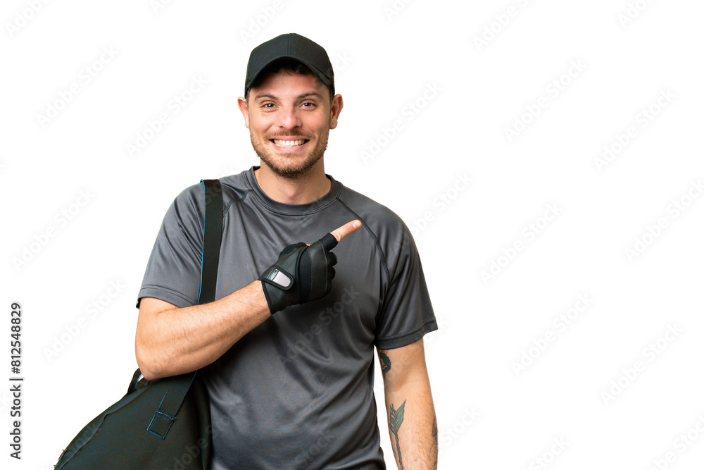 Young sport man with sport bag over isolated chroma key background pointing to the side to present a product Young sport man with sport bag over isolated chroma key background pointing to the side to present a product