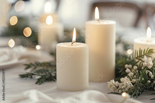 White candles on a table with greenery  minimalist Christmas decorations in a Scandinavian-style home