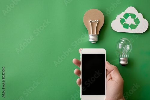 White smartphone in hand, a light bulb © Eduardo Lopez