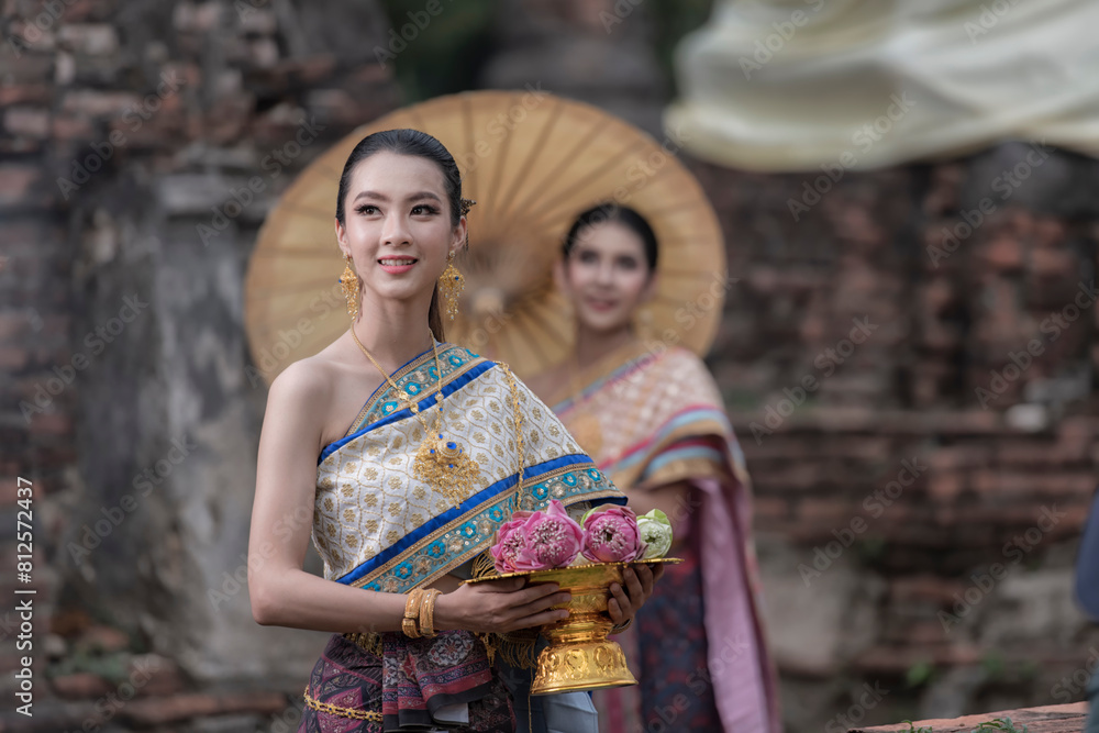 Fototapeta premium women in traditional clothing on historical on background. Portrait women in traditional clothing , Thai traditional in Ayutthaya, Thailand.