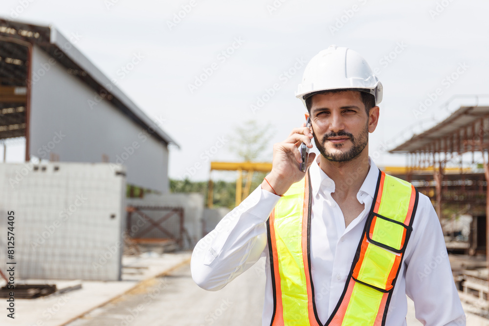 Hispanic male engineer working at construction site. Hispanic male engineer working at construction site.