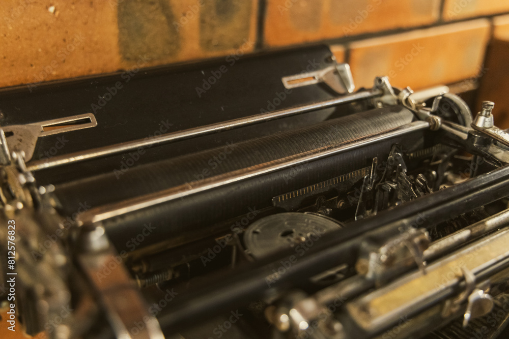 A detailed close-up of an old-fashioned typewriter, showcasing its intricate keys and mechanical components. A detailed close-up of an old-fashioned typewriter, showcasing its intricate keys and mechanical components.