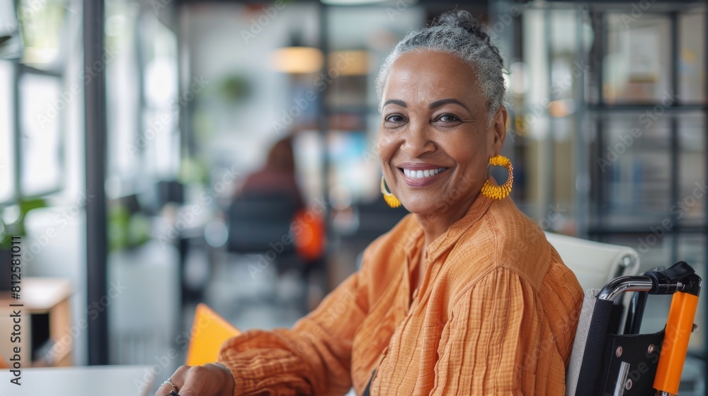 Smiling woman in orange top with yellow earrings seated in a modern office setting. Smiling woman in orange top with yellow earrings seated in a modern office setting.