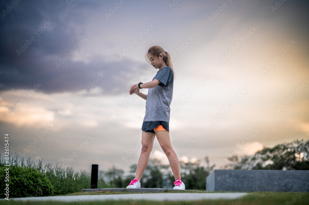 Young woman ,Athlete glancing at her smartwatch. Young woman ,Athlete glancing at her smartwatch.
