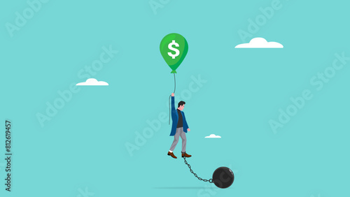 tax burden, business budget barriers, taxation problem for wealth accumulation, businessman fails to fly using a green balloon with a dollar symbol because of the weight ball attached to his feet photo