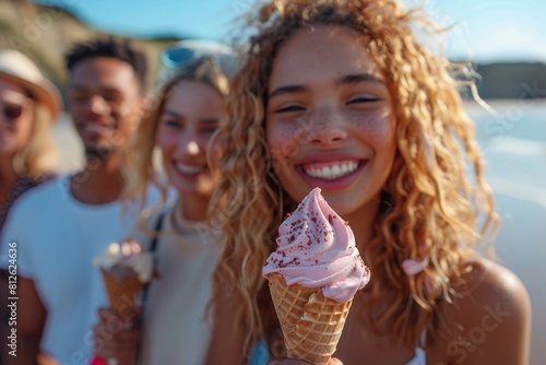 A group of young, happy friends share a moment of joy with ice cream by the sea, epitomizing carefree summer days