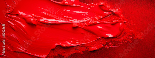 Blurred red paint brush stroke on a red background. Artistic abstract design.